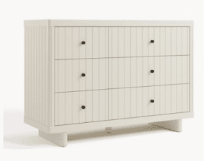 Minimalist white nursery dresser with black knobs