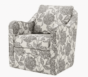 his swivel chair features a loose back and seat cushion that is upholstered in a multi-hued fabric, for a chic transitional look. Double piping details along the frame accent the design, while a black metal base allows the chair to smoothly rotate 360 degrees. Showcasing a clean silhouette and wide seat, this swivel arm chair provides a comfortable update to your home decor.